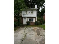 Charming two-story home with a brick front and a cracked driveway at 936 Glynn Oaks Dr, Clarkston, GA 30021