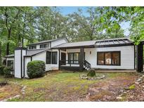 Charming home with black trim, white siding, and a well-maintained yard at 6700 Knollwood Cir, Douglasville, GA 30135