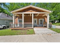 Charming home with a welcoming front porch, complete with porch swing and stylish railings at 999 Smith Sw St, Atlanta, GA 30310