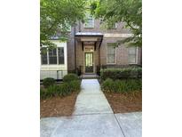 Charming brick townhome with a well-manicured front yard and inviting entrance at 261 Cole Ne St, Marietta, GA 30060