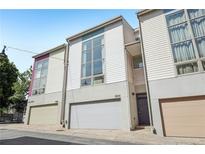 Contemporary townhome featuring a modern facade, individual garages, and large windows for natural light at 1290 Nervi Nw Mews, Atlanta, GA 30318
