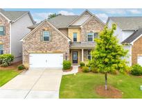 Charming brick two-story home with well-manicured lawn and attached two-car garage at 2887 Regal Park Ct, Duluth, GA 30096