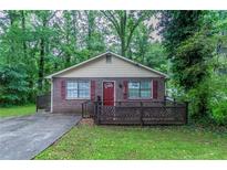 Charming single-story brick home featuring a cozy front porch and well-maintained landscaping at 2045 Scarbrough Dr, Stone Mountain, GA 30088