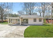 Charming single-story home with a covered carport and inviting front porch at 2826 Ben Hill Rd, Atlanta, GA 30344