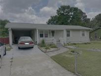 Charming one-story home with a covered carport and a well-maintained front yard at 60 King Blvd, Mcdonough, GA 30253