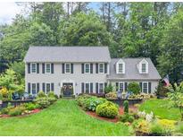 Beautiful two-story home featuring lush landscaping and a manicured lawn at 1540 Kinglet Ln, Marietta, GA 30062