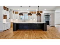Spacious kitchen with a large center island, custom cabinets, and modern pendant lighting at 2153 Cooper Lake Se Rd, Smyrna, GA 30080