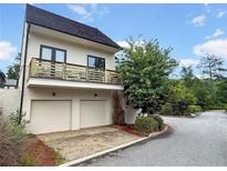 Modern two-story home featuring a balcony, a two-car garage, and a well-maintained landscaped yard at 350 Anders N, Chattahoochee Hills, GA 30268