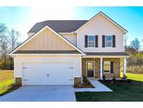 Charming two-story home with a two-car garage, stone accents, and a well-manicured lawn at 471 Charleston Pl, Villa Rica, GA 30180