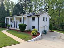 Charming white brick home with landscaped front yard and two-car garage at 1387 Renee Dr, Decatur, GA 30035