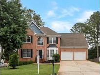 Charming two-story brick home with a well-manicured lawn and attached two-car garage at 2157 Brandon Lee Sw Dr, Marietta, GA 30008