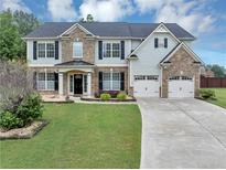 Charming two-story home featuring a brick and siding facade and a well-manicured front yard at 7104 Secret Rose, Douglasville, GA 30134