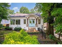 Charming white home featuring a welcoming light blue entry door and beautifully landscaped front yard at 937 Rosedale Ne Rd, Atlanta, GA 30306