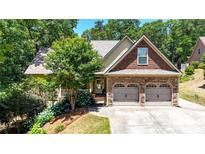 Charming home with stone accents, well-manicured landscaping, and a two-car garage at 34 Laurel Ne Way, White, GA 30184