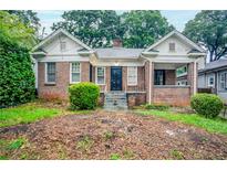 Charming brick home with covered front porch and landscaped yard at 1615 Stokes Sw Ave, Atlanta, GA 30310