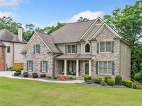 Charming two-story brick home with a well-manicured lawn and inviting front porch at 1898 Alcovy Shoals Se Blf, Lawrenceville, GA 30045