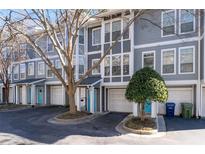 Charming townhome exteriors with a clean color scheme, garages, and inviting blue front doors at 1107 Park Row South Se, Atlanta, GA 30312