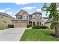 Charming two-story home featuring a brick and siding facade, well-manicured lawn, and an attached two-car garage at 29 Lankford Rd, Tucker, GA 30084