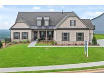 Charming brick home with a well-manicured lawn and inviting curb appeal on a sunny day at 219 Laurel Vista Drive Dr, Canton, GA 30114