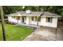 Charming home showcasing a well-manicured lawn, inviting entrance, and a freshly painted exterior at 3978 Oglesby Rd, Powder Springs, GA 30127