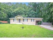 Charming single-story home with a well-maintained lawn and front porch at 220 Harwell Nw Rd, Atlanta, GA 30331