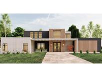 Modern home featuring a stylish mix of white brick, black, and wood paneling, enhancing its curb appeal at 104 Accolade Pkwy, Mcdonough, GA 30252