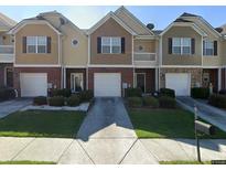 Charming townhouses featuring attached garages and well-maintained landscaping at 2148 Hasel St, Lawrenceville, GA 30044