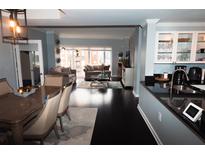 Open-concept living room features dark hardwood floors and bright, sunlit windows at 3475 Oak Valley Ne Rd # 980, Atlanta, GA 30326