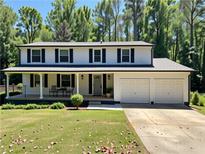 Charming two-story home with a covered front porch, two-car garage, and well-maintained lawn at 2691 Old South Dr, Jonesboro, GA 30236