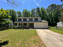 Charming two-story home featuring a welcoming front porch, well-maintained lawn, and a convenient two-car garage at 2691 Old South Dr, Jonesboro, GA 30236