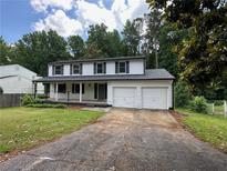 Charming two-story home with a welcoming front porch and a two-car garage at 2691 Old South Dr, Jonesboro, GA 30236