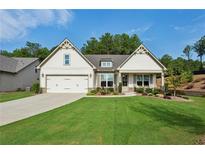 Charming single-Gathering home featuring a well-manicured lawn and attached two-car garage at 400 Southland Cir, Canton, GA 30115