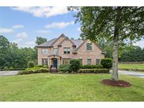Charming two-story brick home with a well-manicured lawn and mature landscaping, enhancing its curb appeal at 602 Davenport Pl, Canton, GA 30115