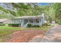 Charming single-story home with a cozy front porch and well-maintained landscaping at 1980 Mcconnell Rd, Grayson, GA 30017