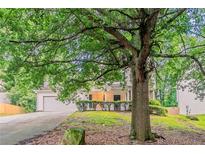 Traditional home with a lush front yard and mature trees providing ample shade at 2341 Alden, Jonesboro, GA 30236