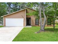 Charming single-story home featuring a well-maintained lawn and inviting curb appeal at 8455 Cedar Creek Rdg, Riverdale, GA 30274