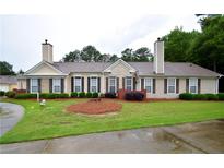 Charming single-story home with well-manicured lawn and mature landscaping creates great curb appeal at 179 Camry Ln, Grayson, GA 30017
