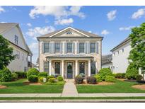 Charming brick home featuring a manicured lawn and a welcoming front porch with elegant columns at 4155 Brookview Dr, Cumming, GA 30040