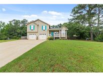 Charming two-story home with a well-manicured lawn, two-car garage, and welcoming front porch at 5 White Pines Dr, Dallas, GA 30157