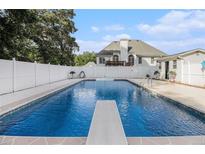 Backyard pool with diving board and white fence at 108 Faraday Dr, Douglasville, GA 30134