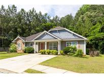 Charming single-story home with stone accents, inviting front porch, and well-manicured lawn at 6770 Gordon Manor Sw Ct, Mableton, GA 30126