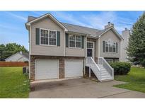 Charming two-story home with a two-car garage and well-maintained landscaping at 1501 Buckingham, Stockbridge, GA 30281