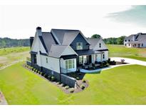 Beautiful two-story home with white and navy siding, black roof, and a well-manicured lawn at 152 Palisade Dr, Rydal, GA 30171