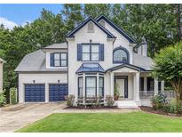 Charming two-story home with blue shutters, gray roof, and lush green lawn at 2804 Stillwater Park Dr, Marietta, GA 30066