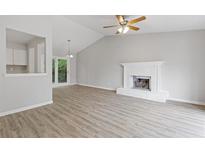 Bright living room with wood floors, fireplace, and sliding glass doors to the outside at 2426 Corner Shoals Dr, Decatur, GA 30034