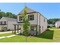 Charming two-story home with white siding, black trim, and well-manicured lawn at 5120 Kongoni Ct, Cumming, GA 30041