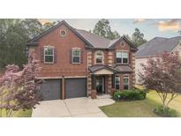 Inviting two-story brick home with well-maintained landscaping and a two-car garage at 8744 Hamil Ct, Douglasville, GA 30135
