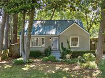 Charming single-story home featuring a landscaped front yard and gray painted brick exterior at 1844 Stanton St, Decatur, GA 30032