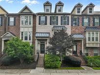 Charming townhome with brick facade, manicured landscaping, and inviting front entrances at 3386 Vintage Se Cir # 8, Smyrna, GA 30080