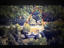 Aerial view of wooded property with property line visible and two homesites at 905 John Ward Rd, Marietta, GA 30064